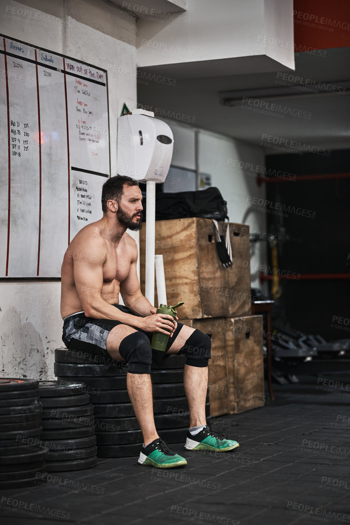 Buy stock photo Rest, fitness and man in gym with smoothie for intense training, exercise and workout for wellness. Sports, athlete and person with fatigue, protein shake and relax for health, recovery and challenge