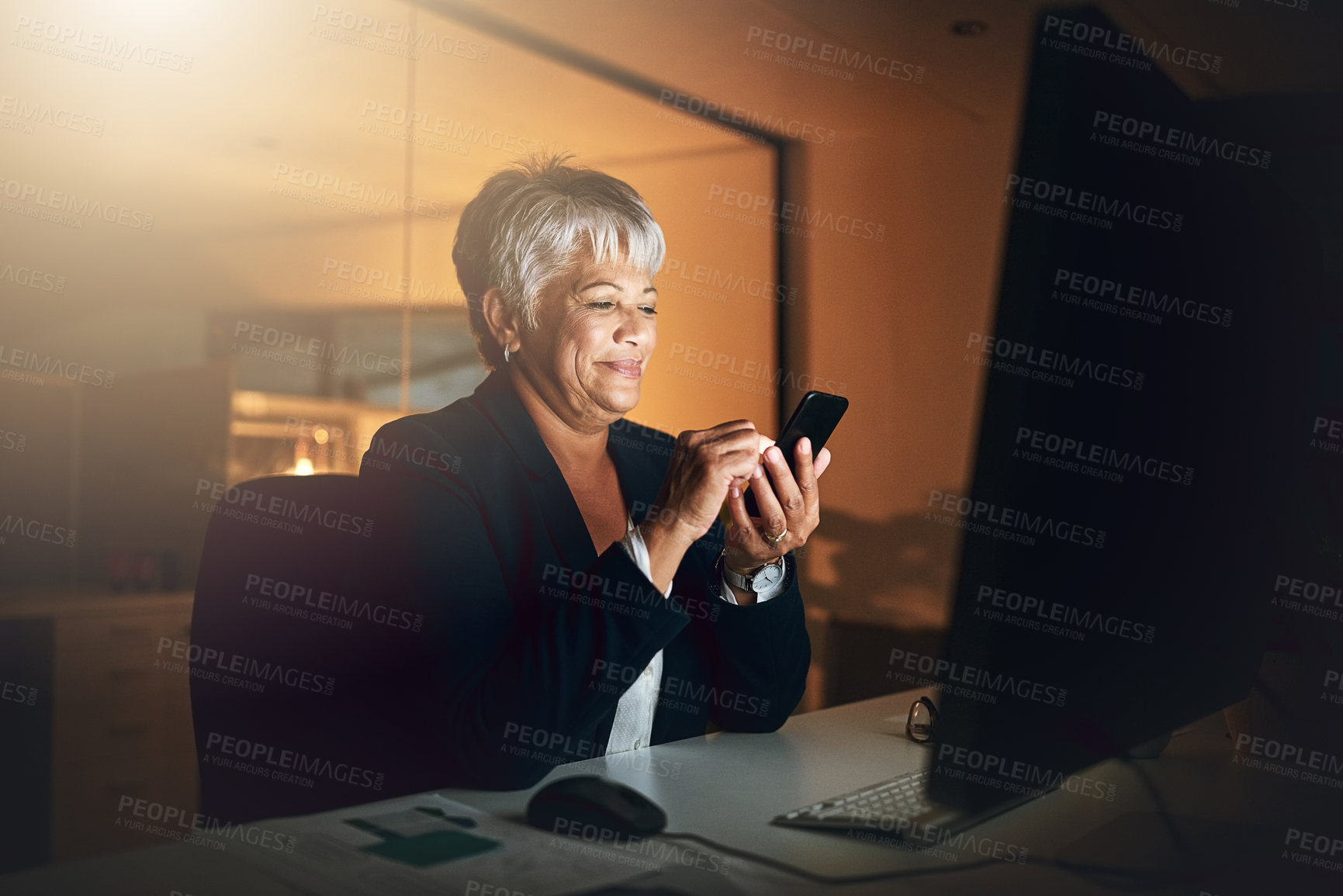 Buy stock photo Office, phone and mature business woman on overtime, reading email and check schedule at night. Mobile, scroll and happy sales manager online with feedback for profit update, revenue growth and news