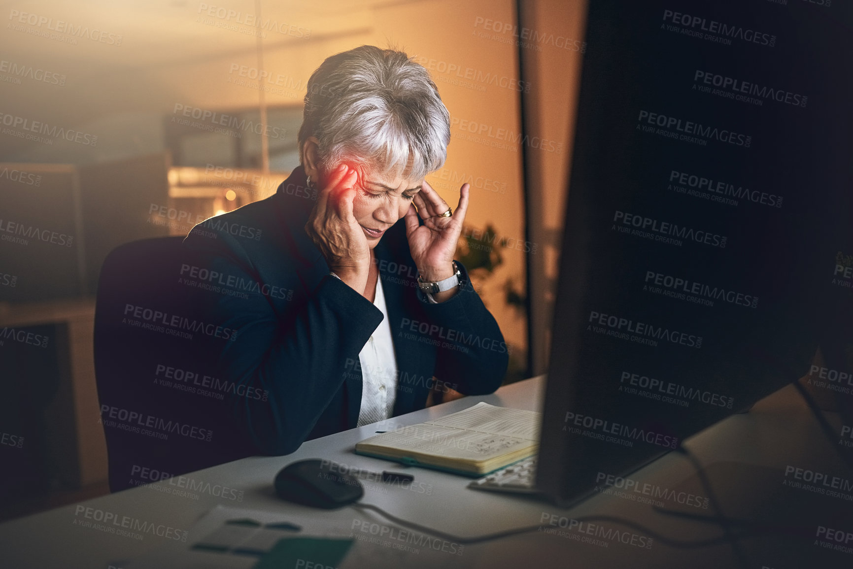 Buy stock photo Shot of a mature businesswoman experiencing a headache during a late night at work