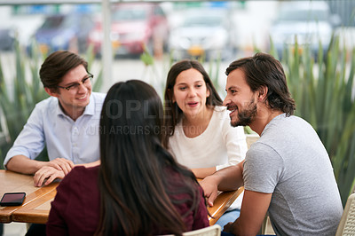Buy stock photo Shot of a group of cheerful young business colleagues enjoying a work function together at a restaurant