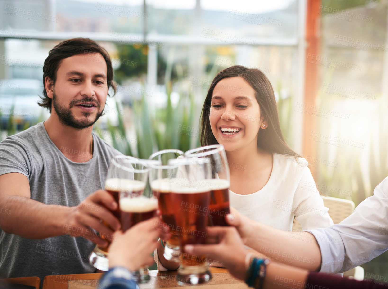 Buy stock photo Friends, man and woman with beer, cheers and social celebration with alcohol at cafe table together. Smile, group and happy people toast in restaurant with drinks, solidarity or weekend reunion event