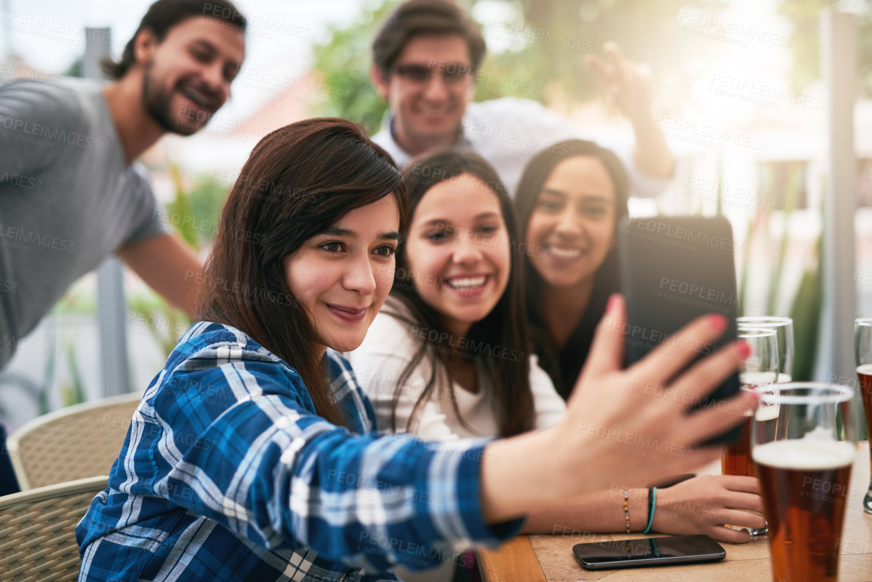 Buy stock photo Shot of a cheerful young group of business work colleagues taking a self portrait together at a restaurant