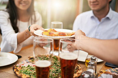 Buy stock photo Shot of a unrecognizable person handing over a slice of pizza to a woman at a restaurant