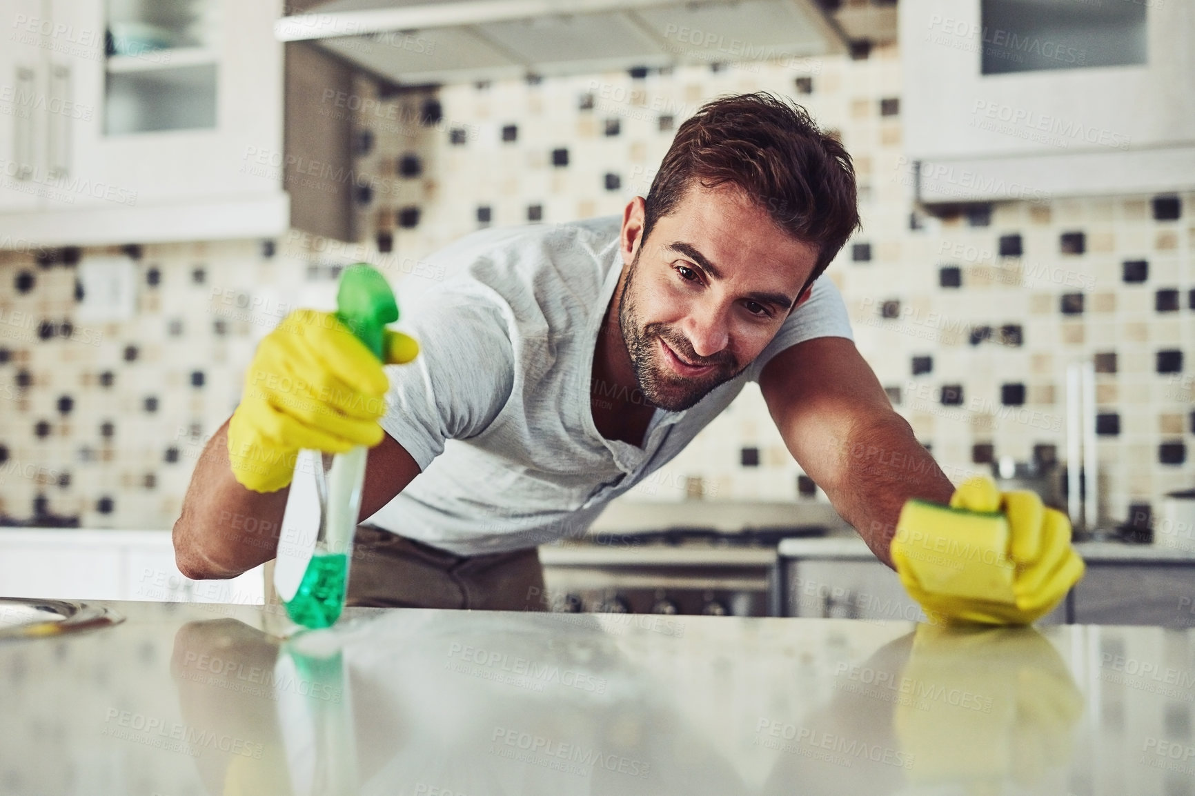 Buy stock photo Shot of a handsome young man cleaning his home