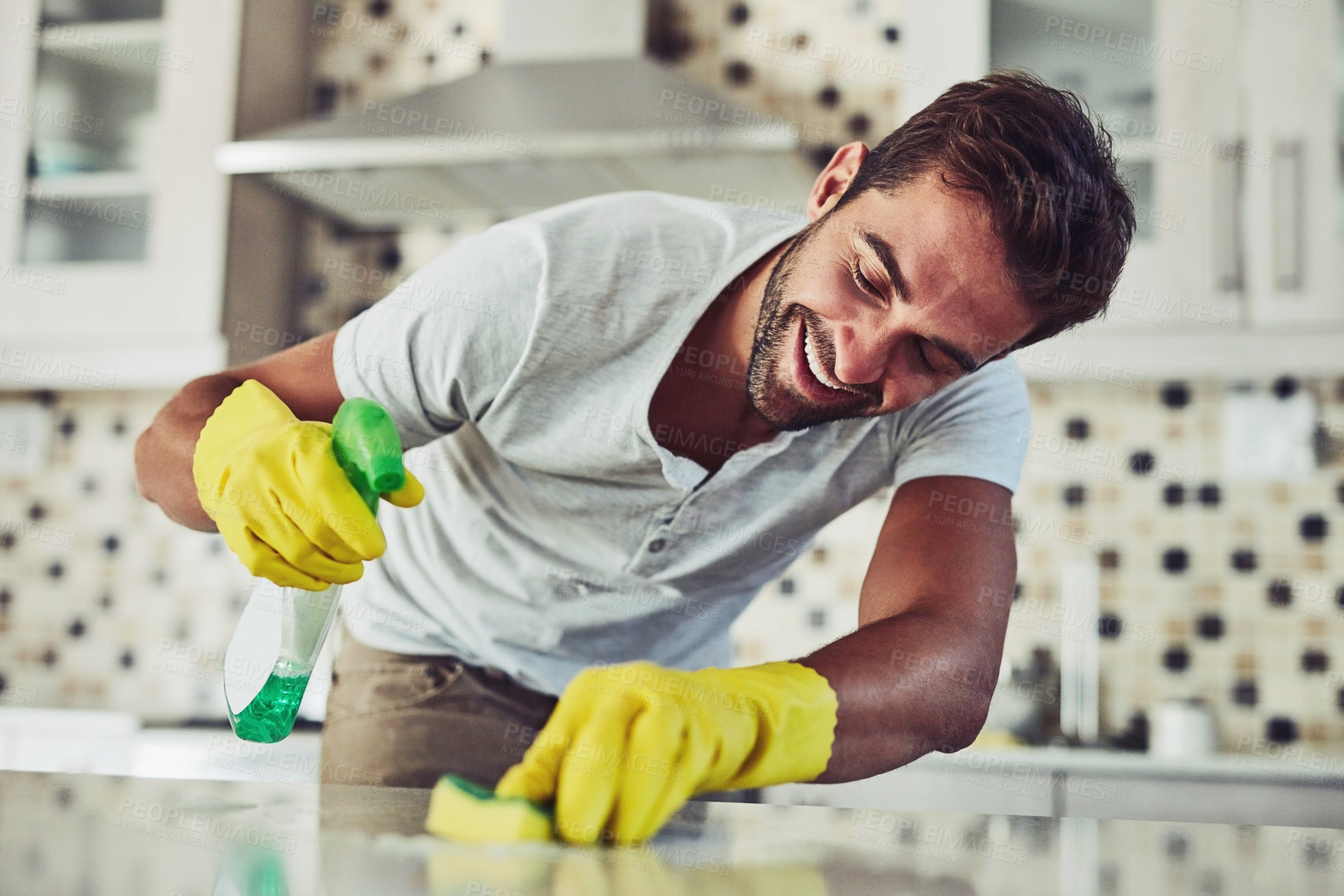 Buy stock photo Shot of a handsome young man cleaning his home