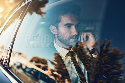 Buy stock photo Cropped shot of a handsome young corporate businessman on a call while commuting