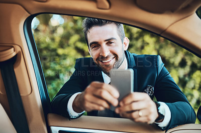 Buy stock photo Cropped shot of a handsome young corporate businessman using a cellphone