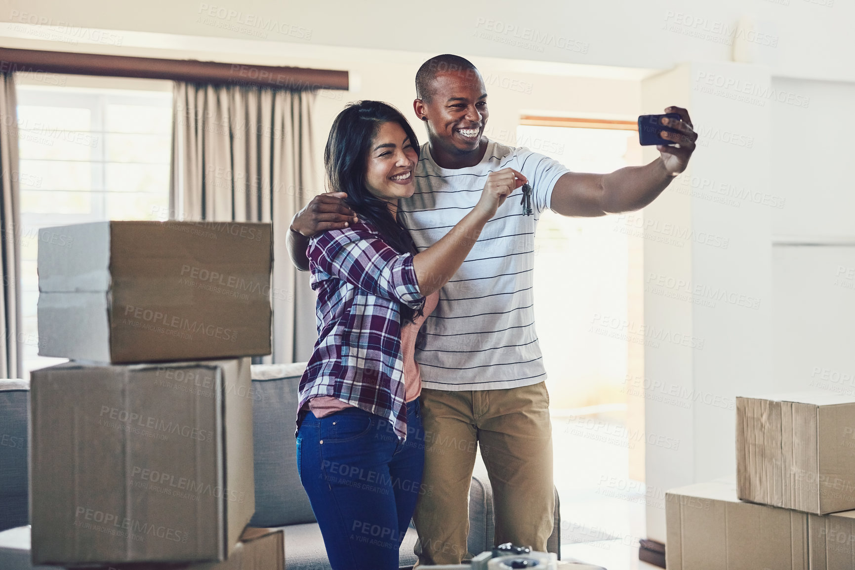 Buy stock photo Happy couple, keys and selfie in new home for moving, real estate and property investment with box. People, memory and rent in house for mortgage success, social media or milestone with loan approval