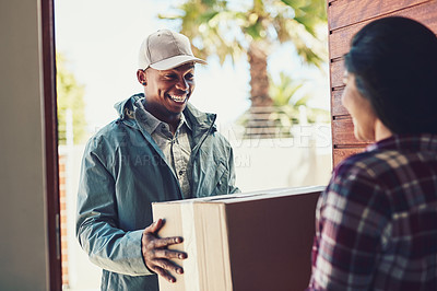 Buy stock photo Shot of a courier making a home delivery to a customer