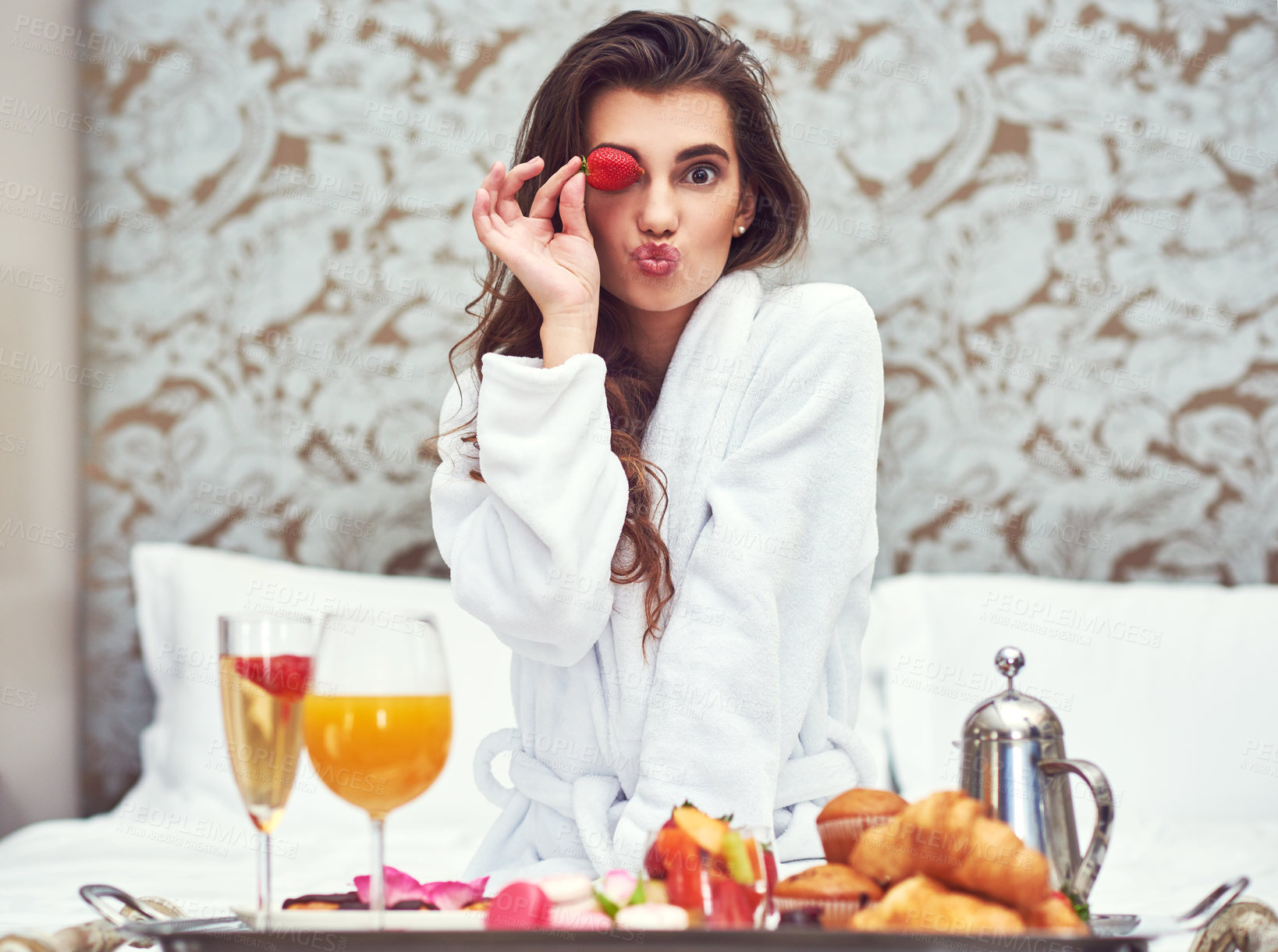 Buy stock photo Shot of an attractive young woman enjoying a luxurious breakfast in her room