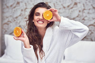 Buy stock photo Orange, beauty and happy with woman in hotel for breakfast, diet and relax. Nutrition, health and natural with female person and cover face with citrus fruit in bedroom for vitamin c, spa and facial