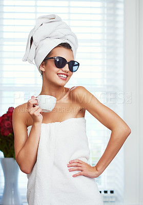 Buy stock photo Shot of an attractive young woman enjoying a cup of coffee while going through her morning routine