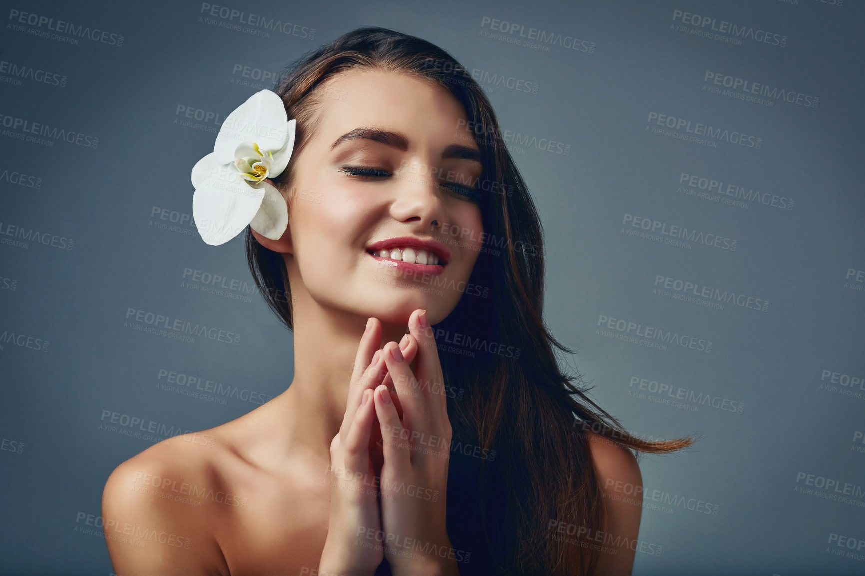 Buy stock photo Beauty, flower and thinking with natural woman in studio isolated on blue background for skincare. Aesthetic, cosmetics and smile with face of happy model for dermatology, idea or satisfaction