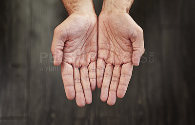 Buy stock photo Studio shot of an unrecognizable person's open hands shown against a dark background