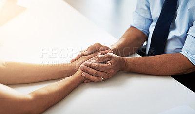 Buy stock photo Shot of a unrecognizable doctor holding a patient's hand to comfort them and make them feel at ease