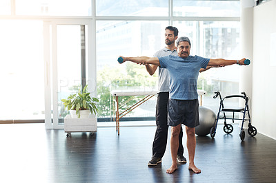 Buy stock photo Training, physiotherapy and stretching with doctor and patient for rehabilitation, dumbbells and help. Healthcare, wellness and healing with old man and expert for consulting, muscle and exercise