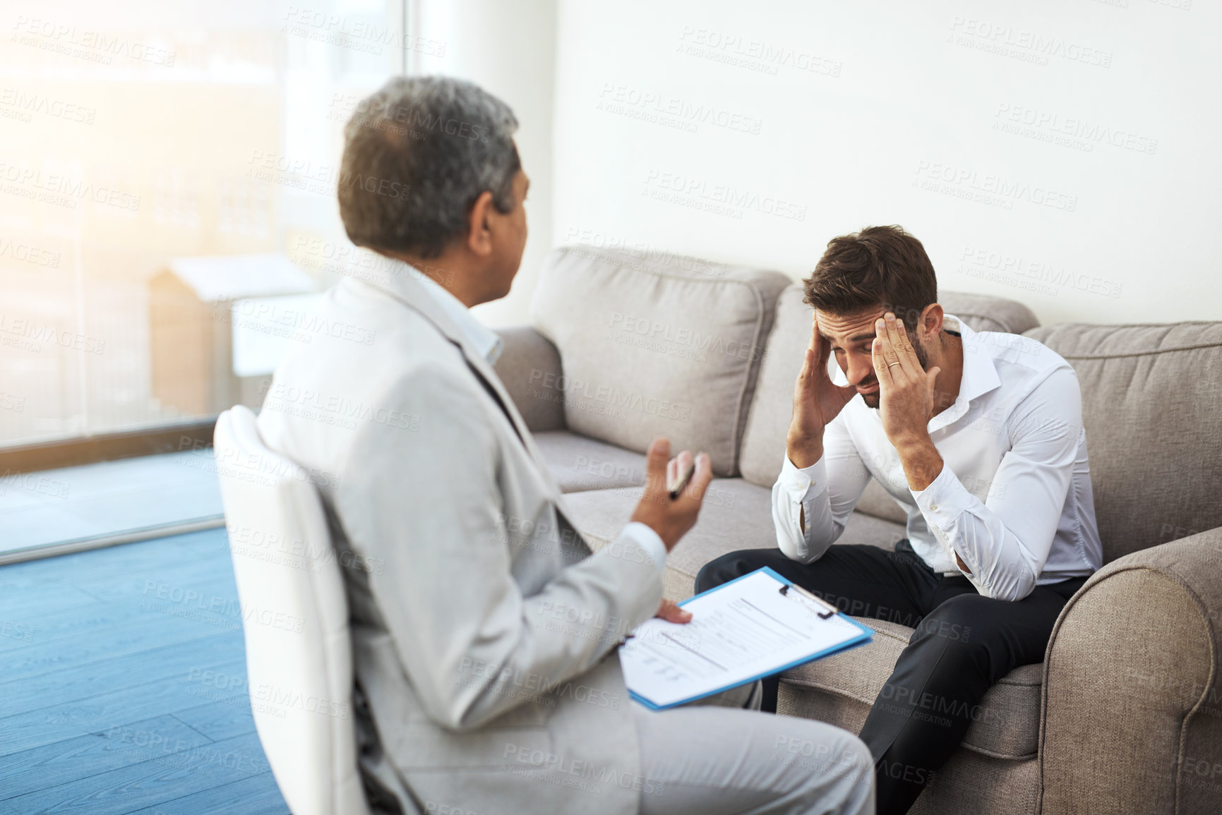 Buy stock photo Men, doctor and patient at office with headache on consultation, checkup and examination. People, healthcare and discussion with document for migraine symptoms, sickness and diagnosis at clinic