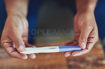 Buy stock photo High angle shot of an unidentifiable woman taking a pregnancy test at home