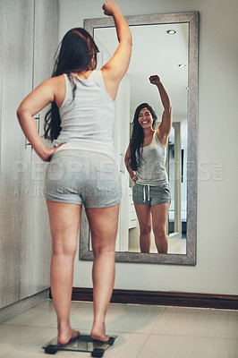 Buy stock photo Celebration, weight loss goal and woman with scale and diet success in a home with mirror reflection. Cheering, happy and female person in a house with nutrition progress and a smile from wellness