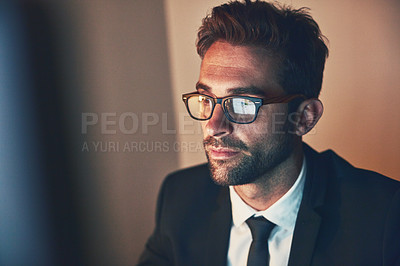 Buy stock photo Cropped shot of a handsome young businessman working late in the office