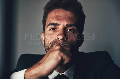 Buy stock photo Cropped portrait of a handsome young businessman working late in the office