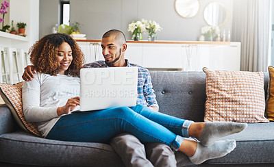 Buy stock photo Happy, relaxed and carefree couple bonding together on the sofa in the living room at home. Loving, affectionate and smiling boyfriend and girlfriend relaxing, typing and browsing on a laptop