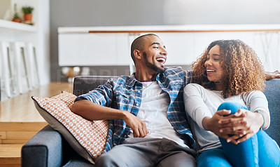 Buy stock photo Happy, relaxed and carefree couple bonding on the couch together at home. Loving, affectionate and smiling boyfriend and girlfriend relaxing in the living room. Sitting down and enjoying the weekend