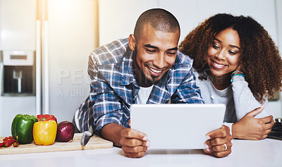 Buy stock photo Happy couple, tablet and cooking healthy meal with recipe in kitchen at home on internet, website and online connection. Man, African woman and technology for reading instructions on vegan food blog 