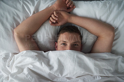 Buy stock photo Cropped shot of a shirtless young man relaxing in his bedroom