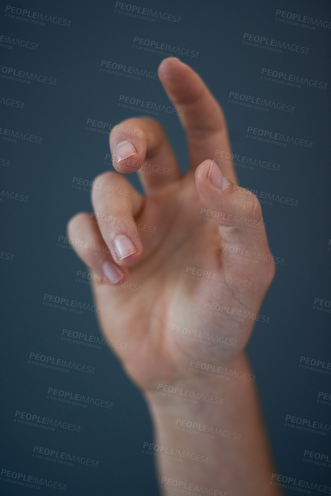 Buy stock photo Studio shot of an unrecognizable man's hand against a blue background