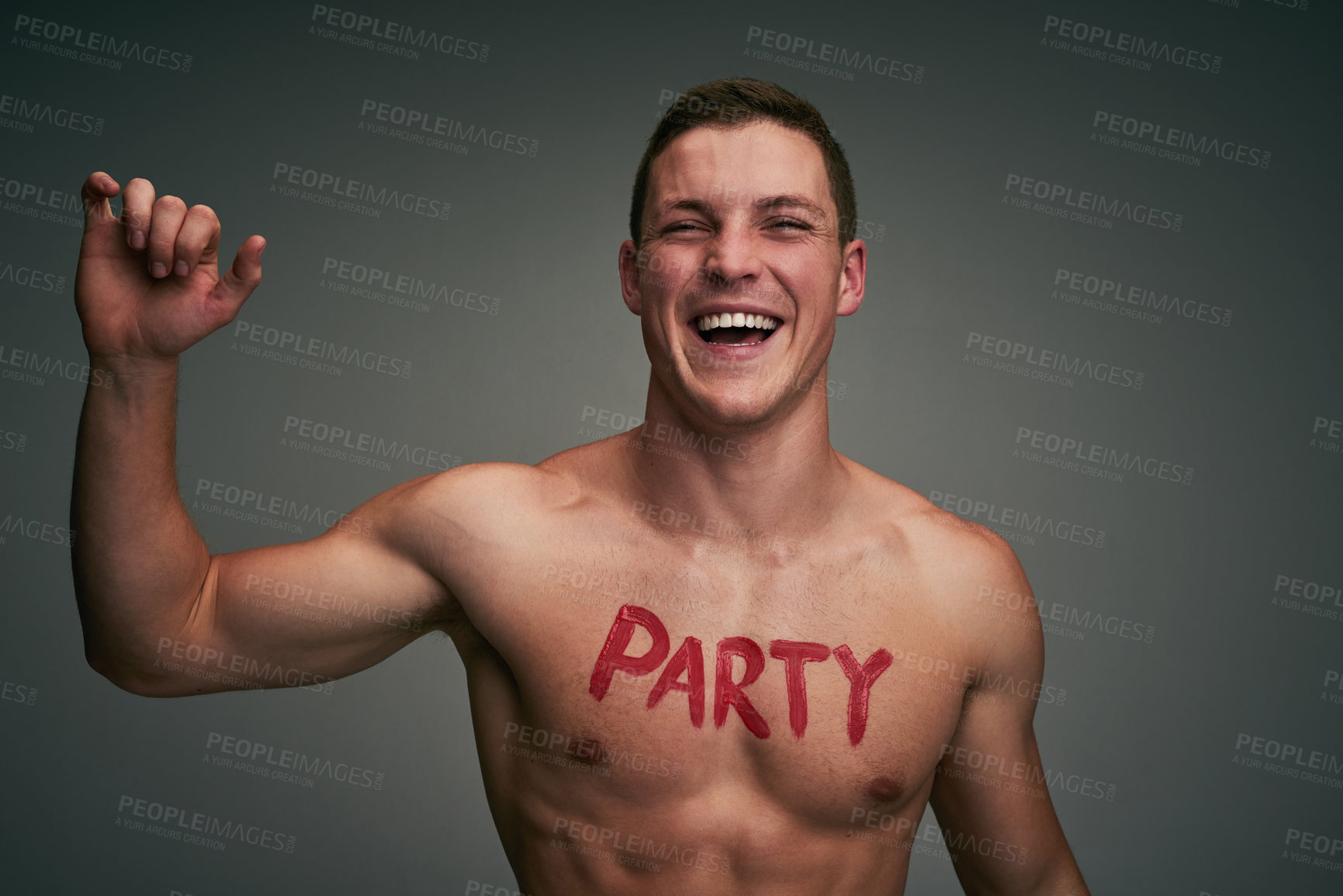 Buy stock photo Shirtless, party and man in studio happy for celebration, spring break and college festival. Excited, smile and portrait of confident person with writing, text and words on chest on gray background