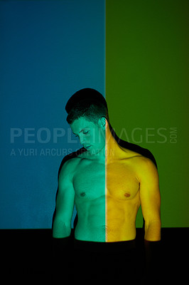 Buy stock photo Studio shot of a young man posing against abstract lighting