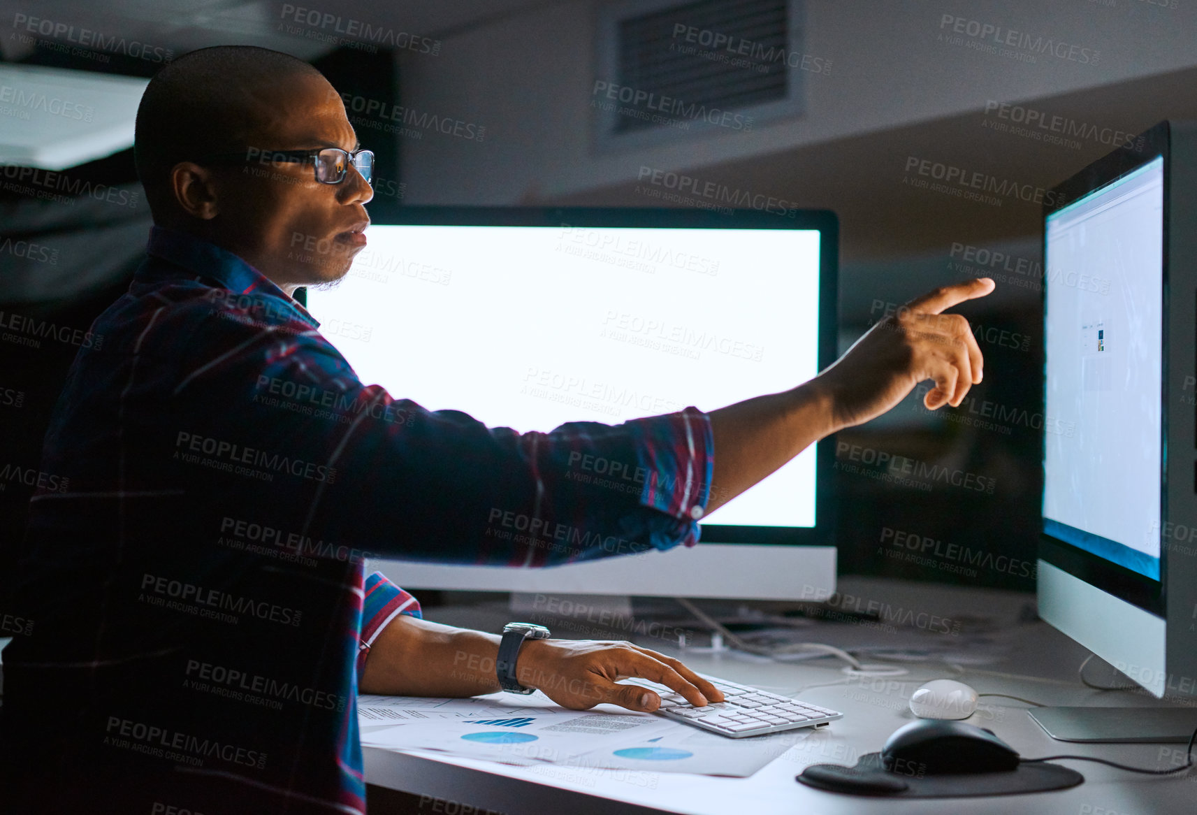 Buy stock photo Cropped shot of a young male programmer working on computer code in his office