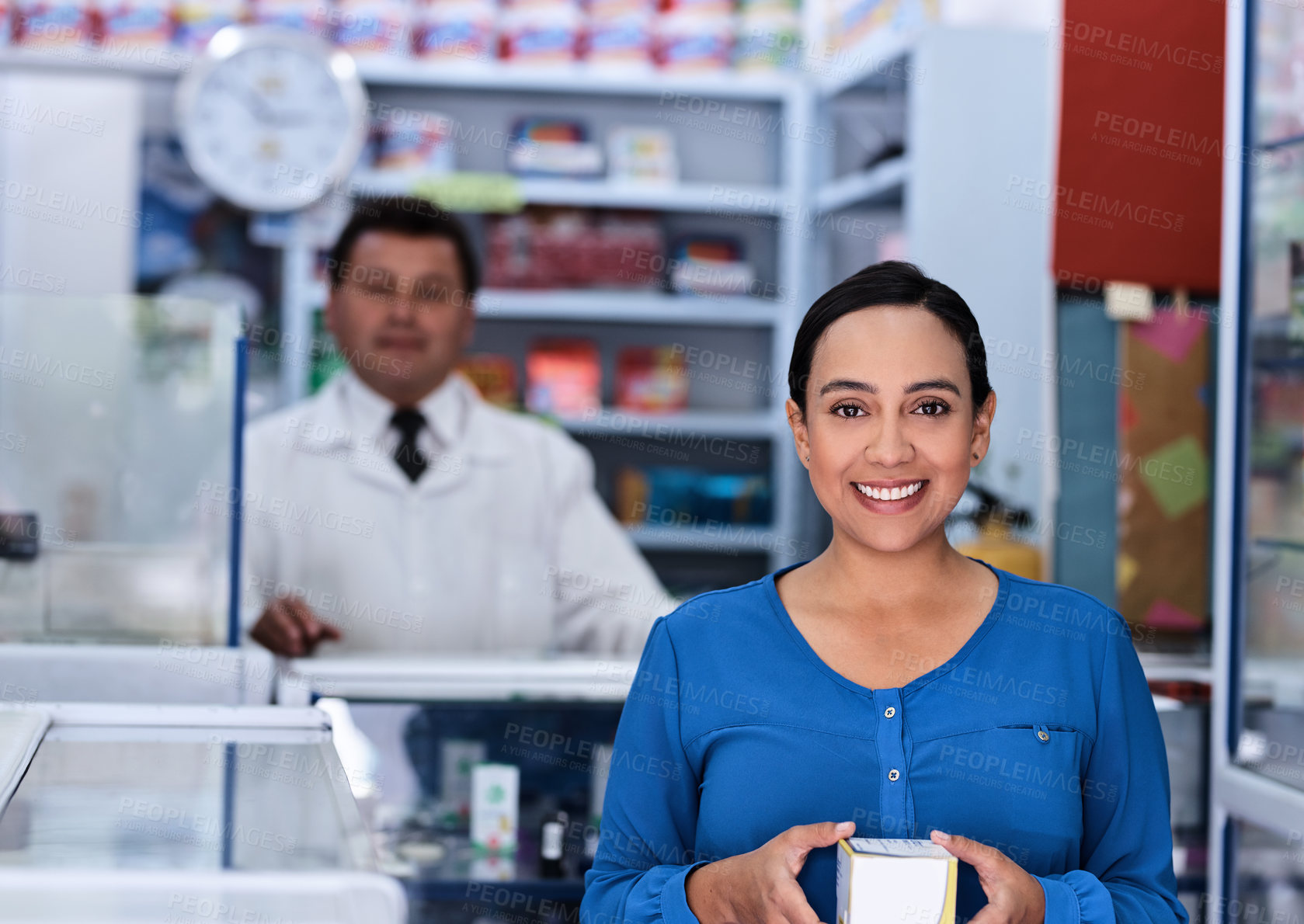 Buy stock photo Shot of a male pharmacist and female customer in a pharmacy