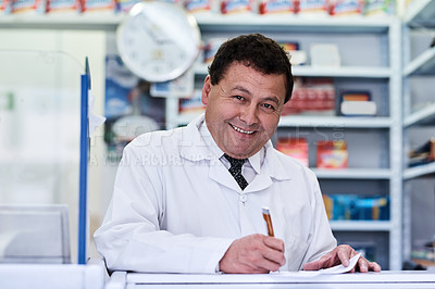 Buy stock photo Shot of a male pharmacist working in a pharmacy