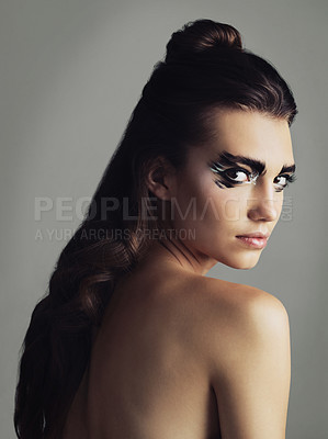 Buy stock photo Studio shot of an attractive young woman wearing bold eye makeup