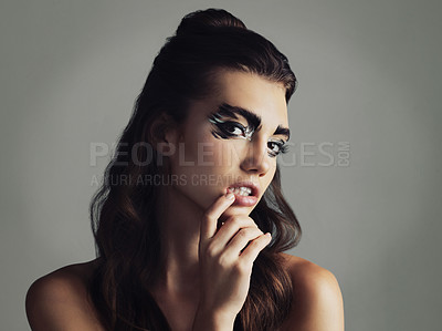 Buy stock photo Studio shot of an attractive young woman wearing bold eye makeup