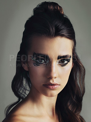 Buy stock photo Studio shot of an attractive young woman wearing bold eye makeup