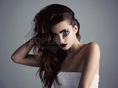 Buy stock photo Studio shot of an attractive young woman wearing bold makeup