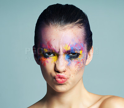 Buy stock photo Paint makeup, angry, portrait of woman for cosmetics isolated on gray studio background. Frown, beauty and face of gen z model with color art for skincare, fantasy and abstract aesthetic in Italy