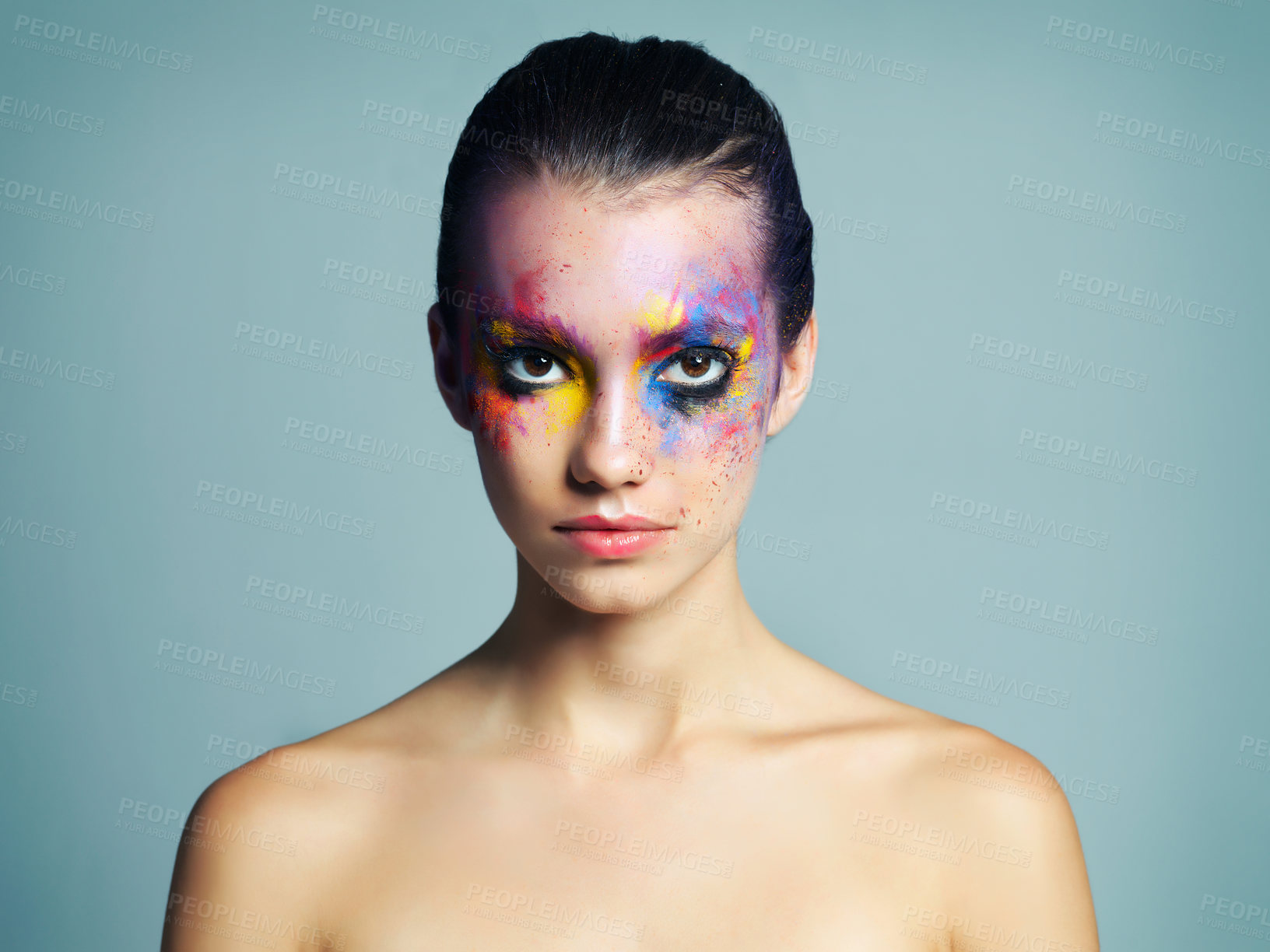 Buy stock photo Creative, face and makeup with portrait of woman for artistic cosmetics, splash and fantasy. Female person, serious and confidence with colorful paint for unique, beauty or shine by studio background