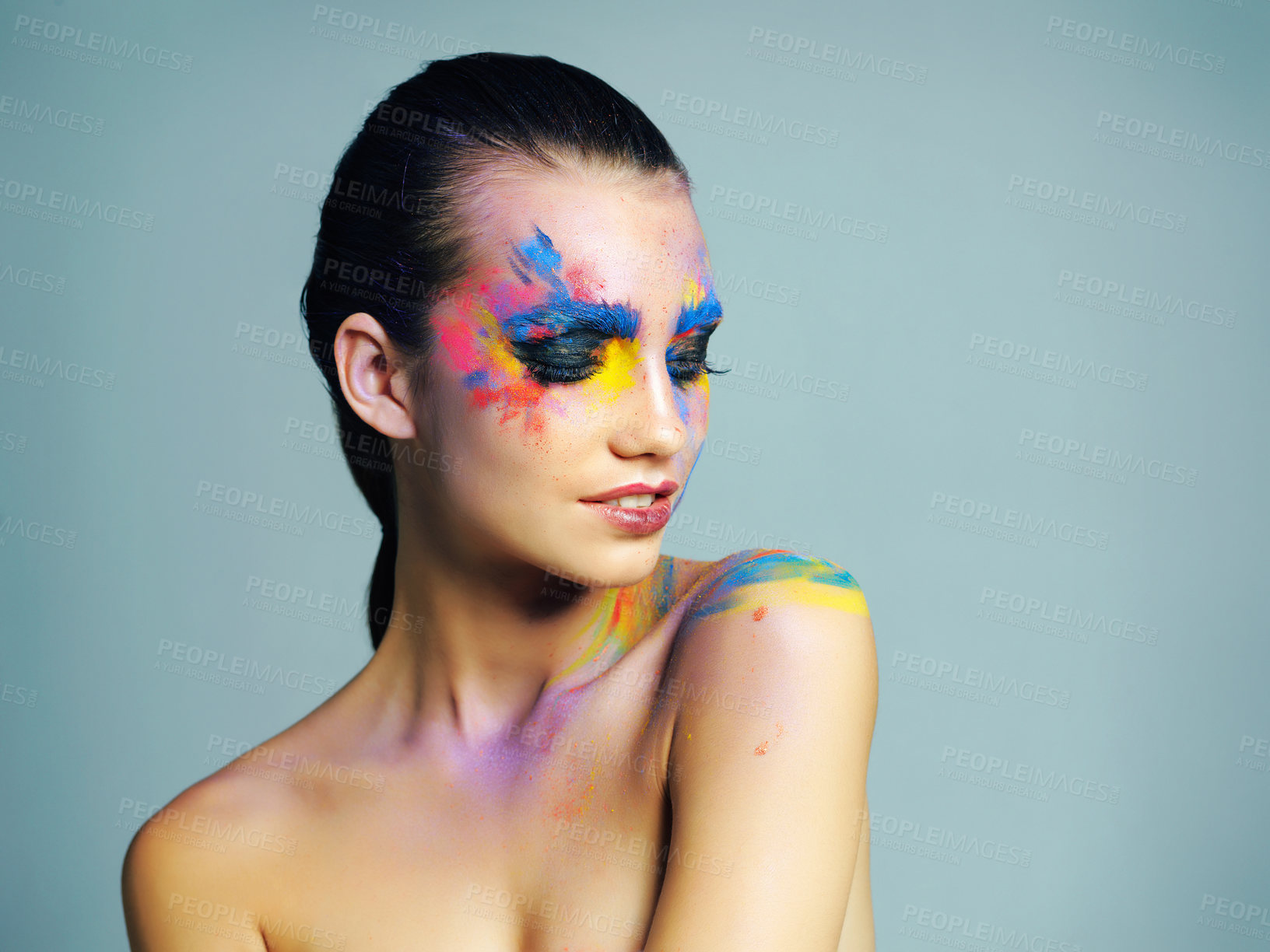 Buy stock photo Face paint, colorful or woman in studio with space, cosmetics or body art on blue background. Creative, beauty mockup and artistic model with confidence for makeup, fantasy and abstract aesthetic