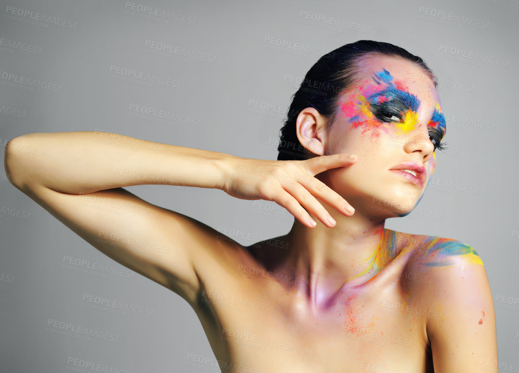 Buy stock photo Face paint, portrait and beauty of woman in makeup isolated on gray studio background. Creative, art and model touch skin with color cosmetics for fantasy, abstract and aesthetic with lgbtq rainbow