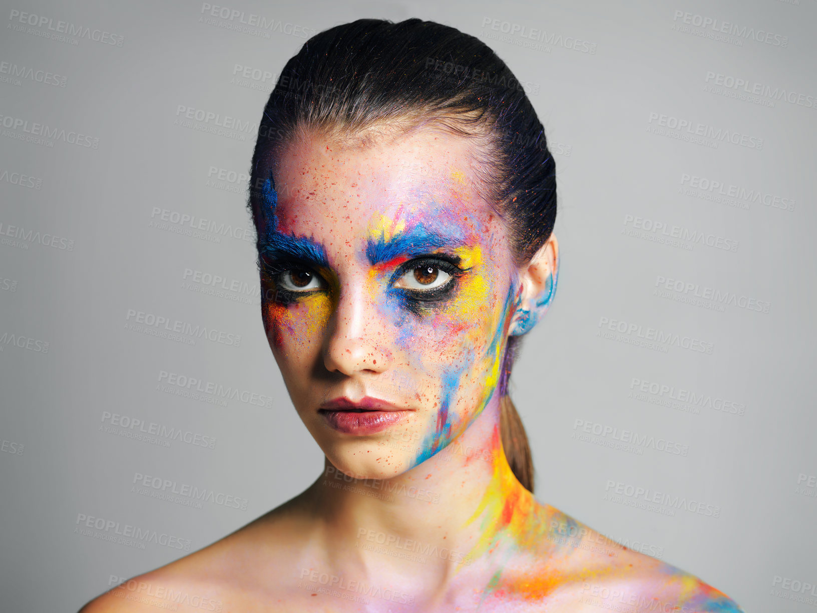 Buy stock photo Face paint, art and beauty of woman in makeup isolated on gray studio background. Creative, thinking and young model with color cosmetics on skin for abstract, fantasy or aesthetic of lgbtq rainbow