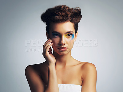 Buy stock photo Woman, portrait and face paint in studio, creative makeup and skincare on gray background. Female person, unique and confident with abstract aesthetic, art and identity of artist in beauty cosmetics