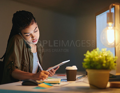 Buy stock photo Shot of a young businesswoman on a call and using a tablet at the office