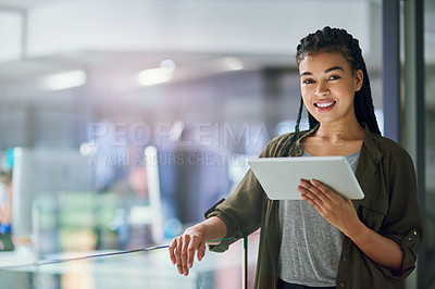 Buy stock photo Shot of a young businesswoman using a tablet at the office