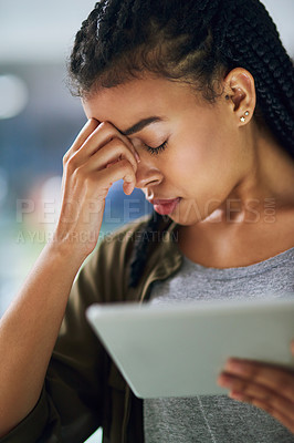 Buy stock photo Shot of a young businesswoman experiencing a headache at the office
