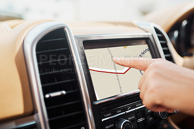 Buy stock photo Cropped shot of an unrecognizable woman using her GPS while driving