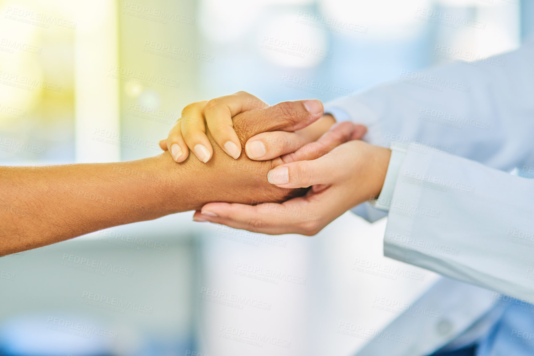 Buy stock photo Closeup shot of an unrecognizable doctor holding a patient's hand in comfort
